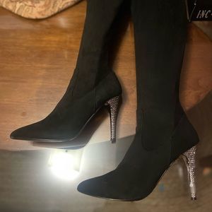 Over-the-knee tall boot, pointed toe, rear zipper, bling 4” stiletto heel.